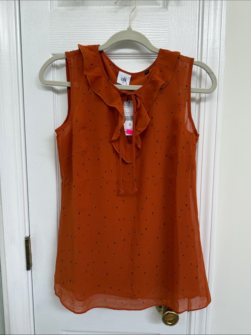 NEW WITH TAG 
CeCe Rust Sleeveless Ruffle Tie-Neck Camisole with Black Dot Print